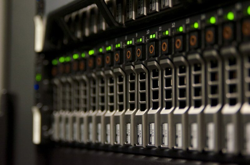 Server rack with blinking green lights representing database infrastructure