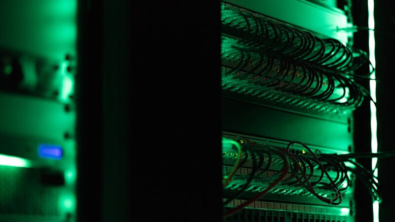 Rack of electronic equipment in a dark server room