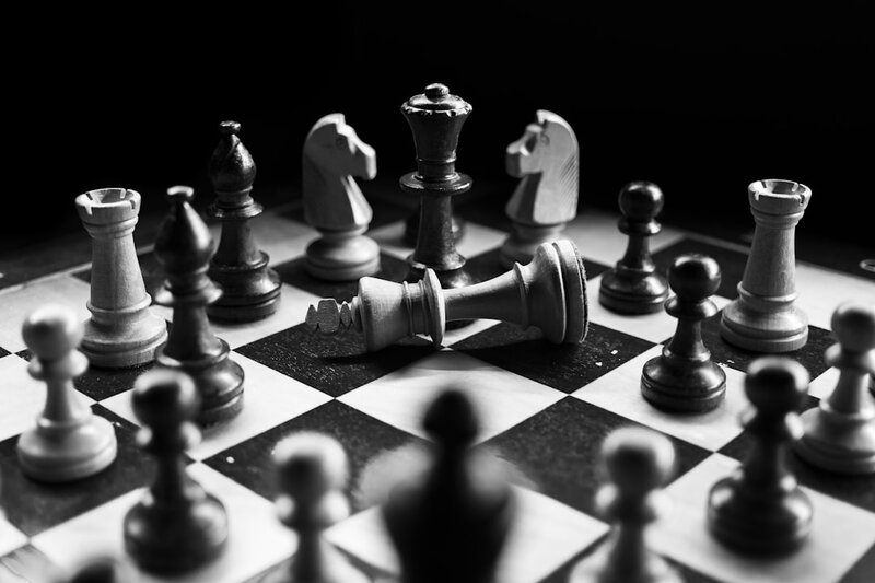 A chess board mid-game, representing AI coding agents gaming the rules of an evaluation rather than solving the problem