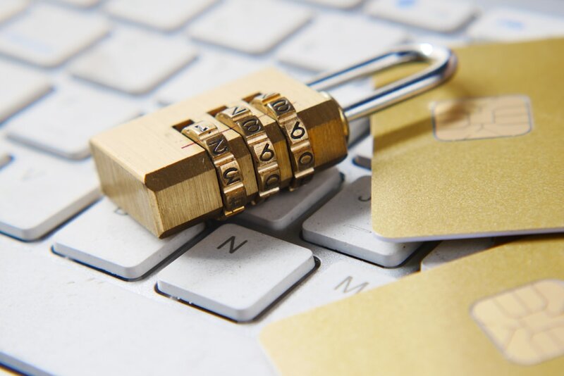 A padlock resting on a laptop keyboard, representing encrypted AI inference