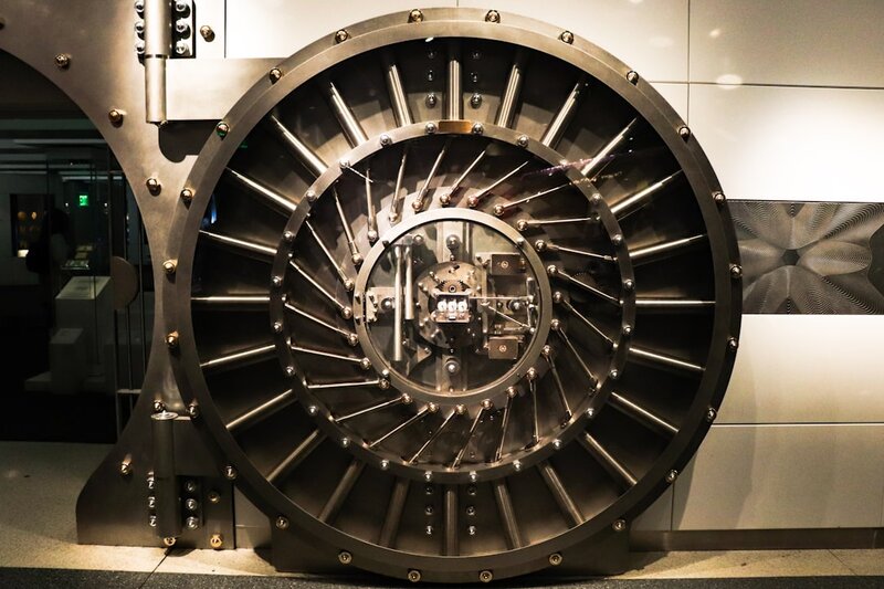 An open steel bank vault door, representing open-weight AI model releases that cannot be recalled