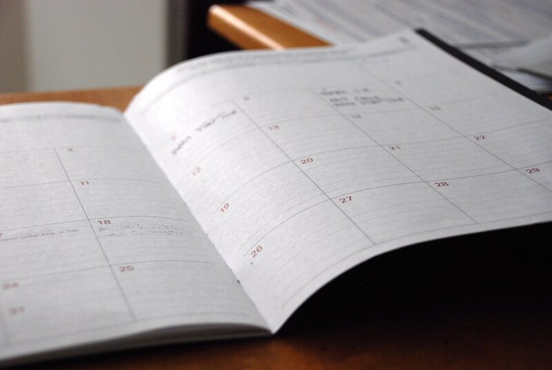 Open monthly planner on a wooden desk