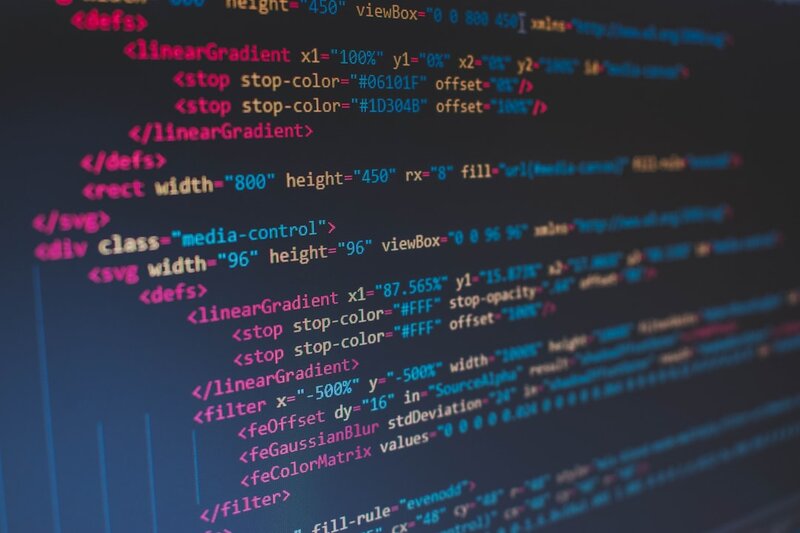 Lines of code on a screen, representing programming language choice for AI coding agents