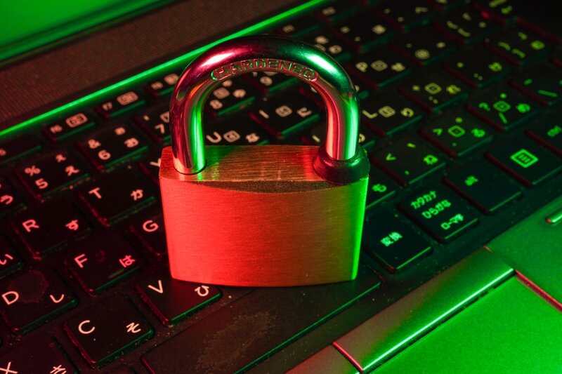 Red padlock resting on a black computer keyboard
