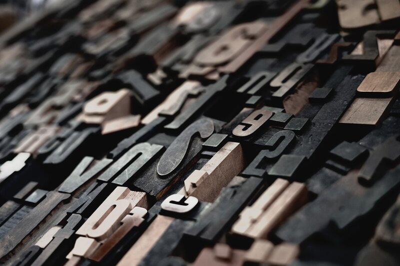 Close-up of cut-out letter shapes, representing character identity and Unicode string comparison