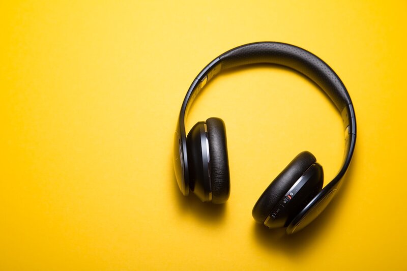 Flat lay of wireless Bluetooth headphones on a plain surface