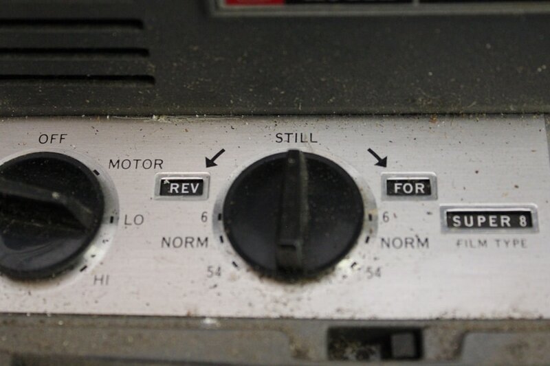 Control panel of a Super 8 film projector showing REV and FOR switches