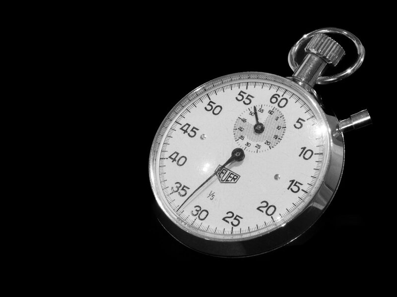 Close-up of a mechanical stopwatch on a black background