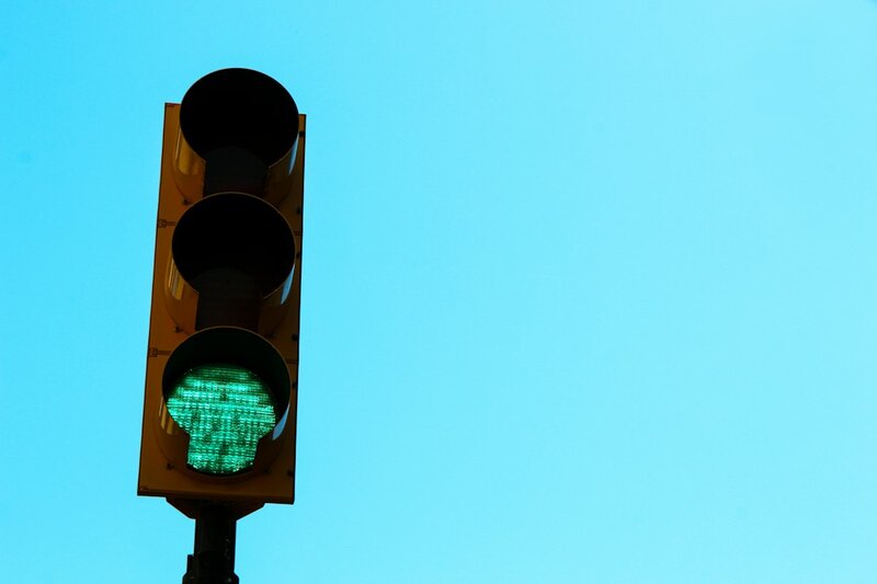 A traffic light showing green at night