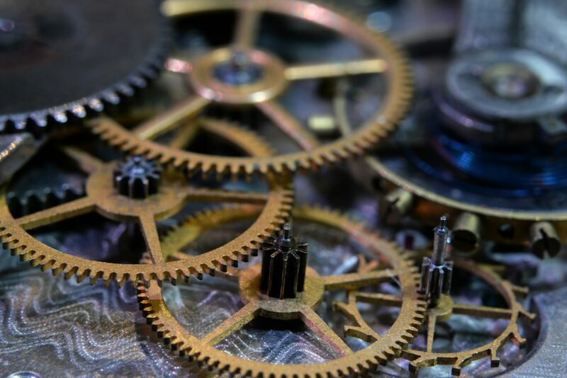 Close-up of brass clock gears and a watch movement mechanism