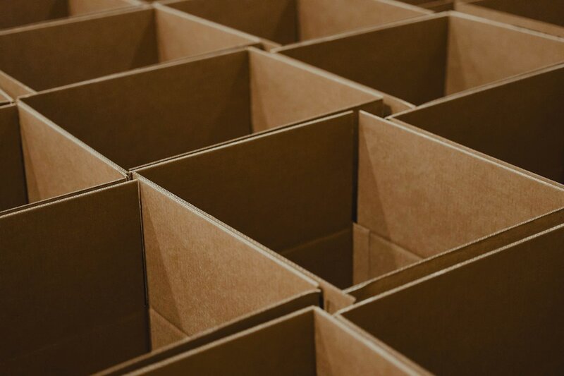 A grid of identical open brown cardboard boxes, indistinguishable from one another