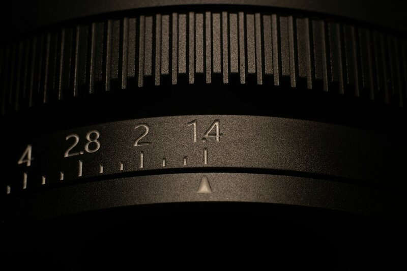 Close-up of a camera lens aperture ring showing f-stop markings