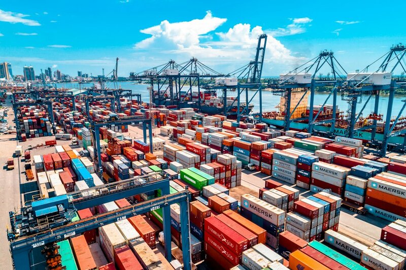 Shipping containers stacked in a port, standing in for npm packages arriving without a verifiable record of where they were built