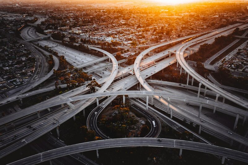 Aerial view of a multi-level motorway interchange at sunset