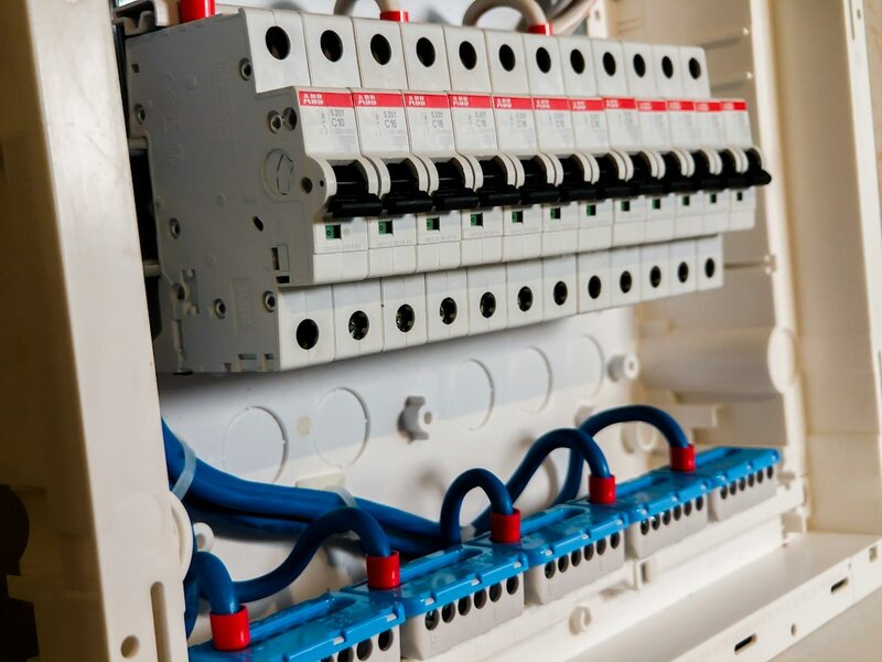 Row of white circuit breakers in an open consumer unit